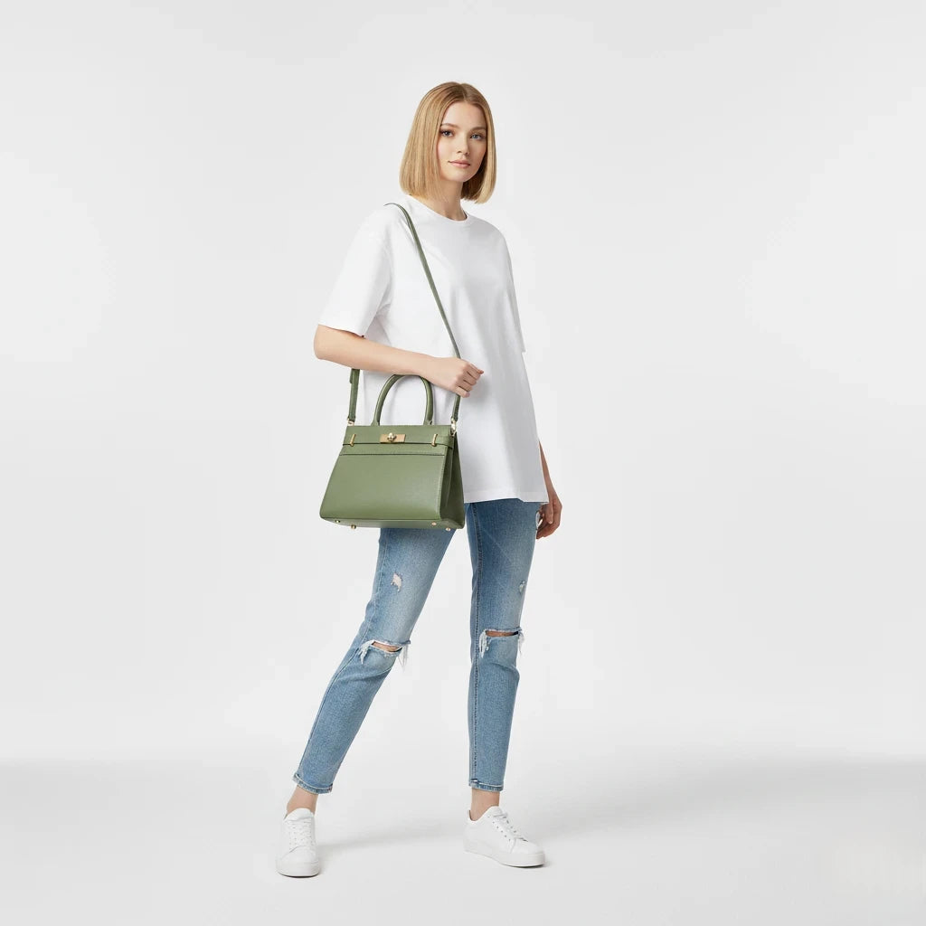 Woman holding a green handbag against a white background
