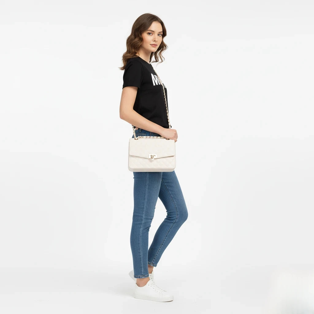 Woman holding a white handbag on a white background