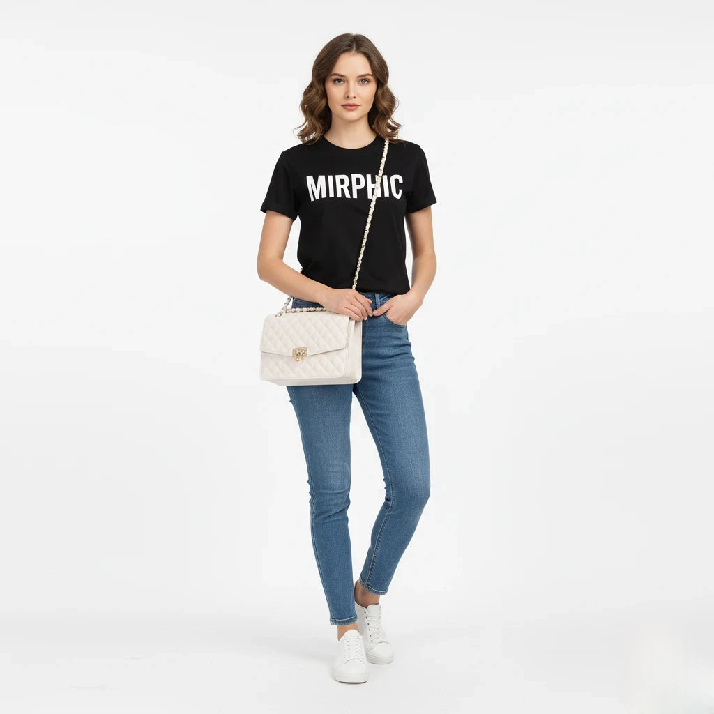 Woman wearing a black t-shirt with 'MIRPHIC' text, blue jeans, and white sneakers on a white background.