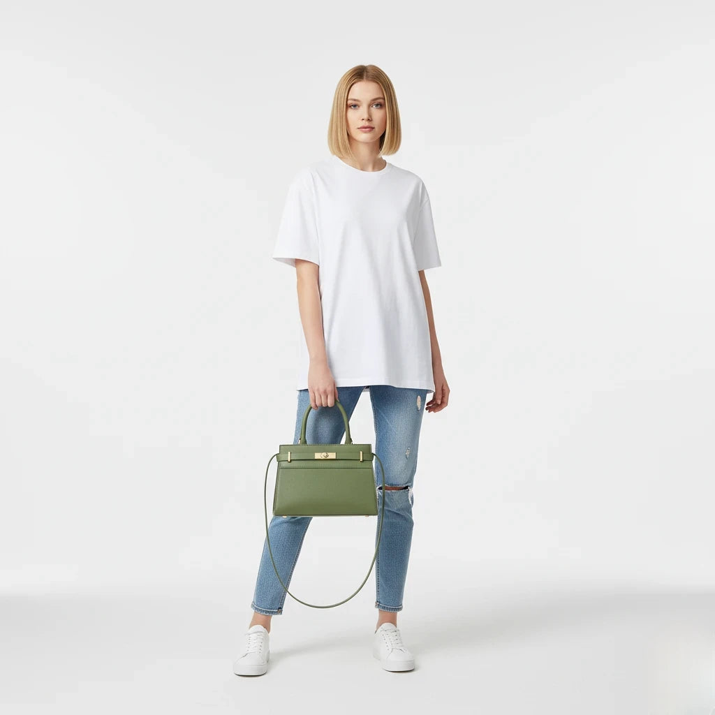 Woman holding a green handbag against a white background