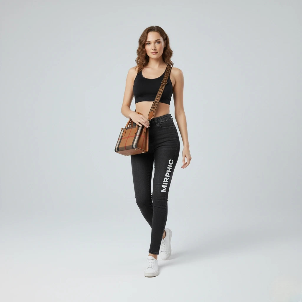 Woman wearing black leggings with 'MIRPHIC' branding, holding a brown bag on a light gray background
