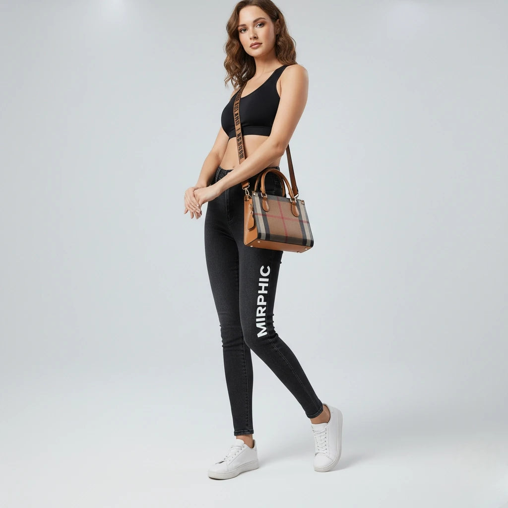 Woman wearing black leggings with 'MIRPHIC' branding, holding a brown handbag on a light gray background