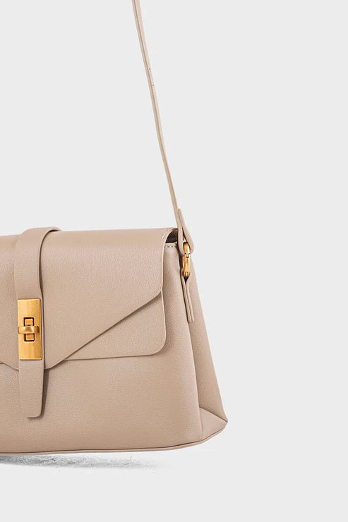 Beige handbag with a gold clasp on a light gray background