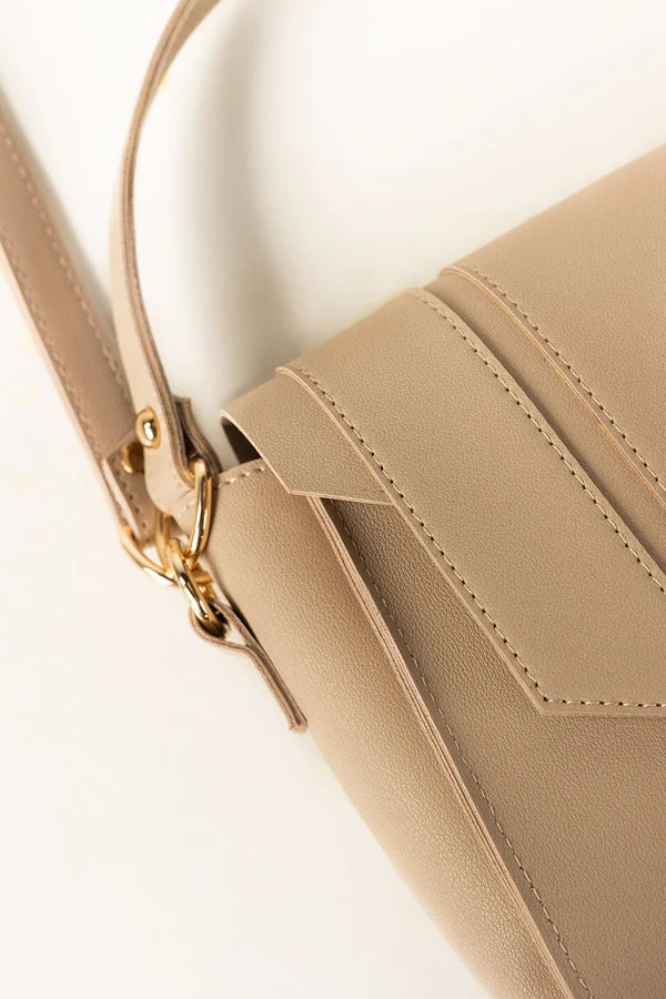 Beige handbag with a gold clasp on a light beige background