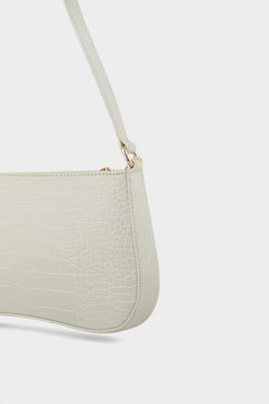 Light gray handbag with a strap on a white background