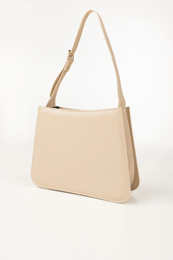 Beige handbag with a shoulder strap on a white background