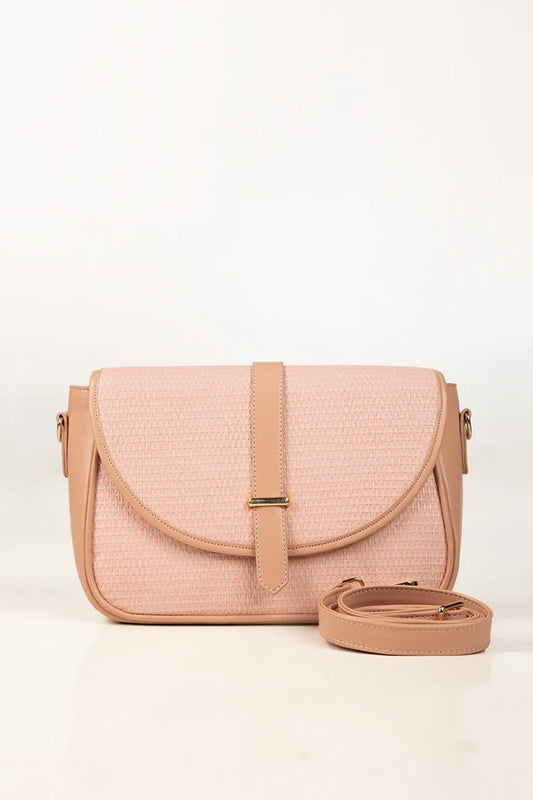Pink textured handbag with a strap on a white background