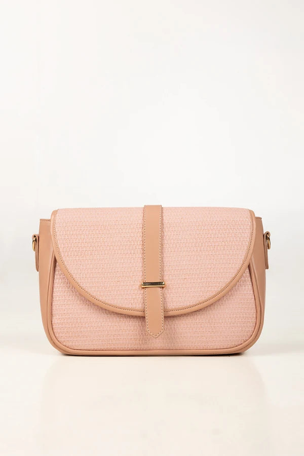 Pink textured handbag with a strap on a white background