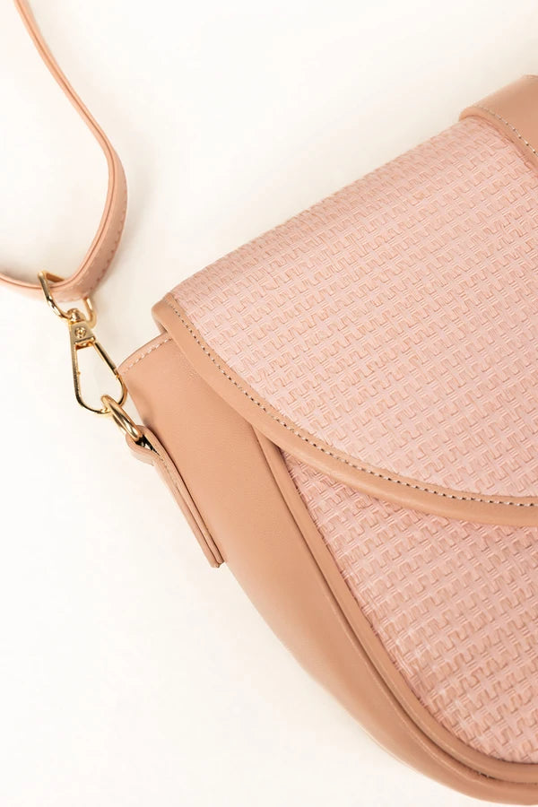 Pink textured handbag with a gold clasp on a white background