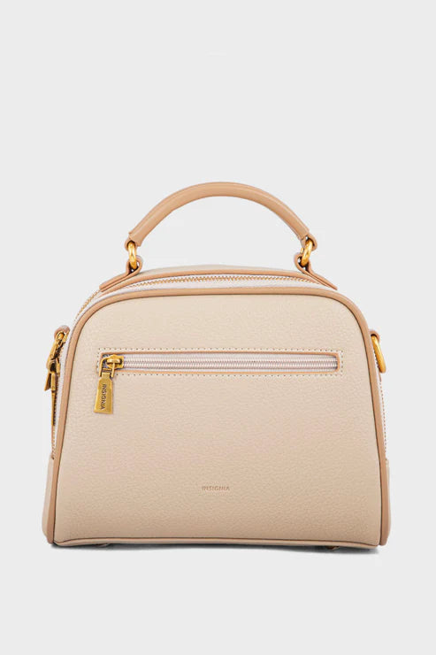 Beige handbag with gold accents on a light gray background