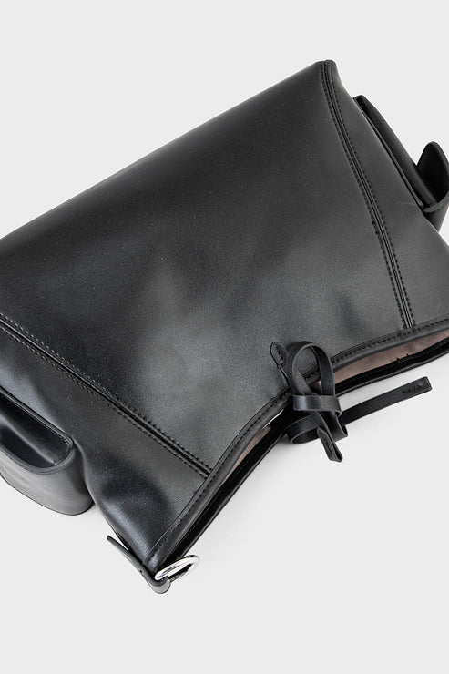 Black leather bag with a strap on a white background