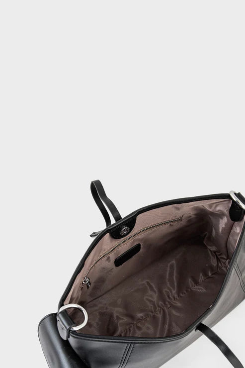 Black backpack with open front compartment on a light gray background