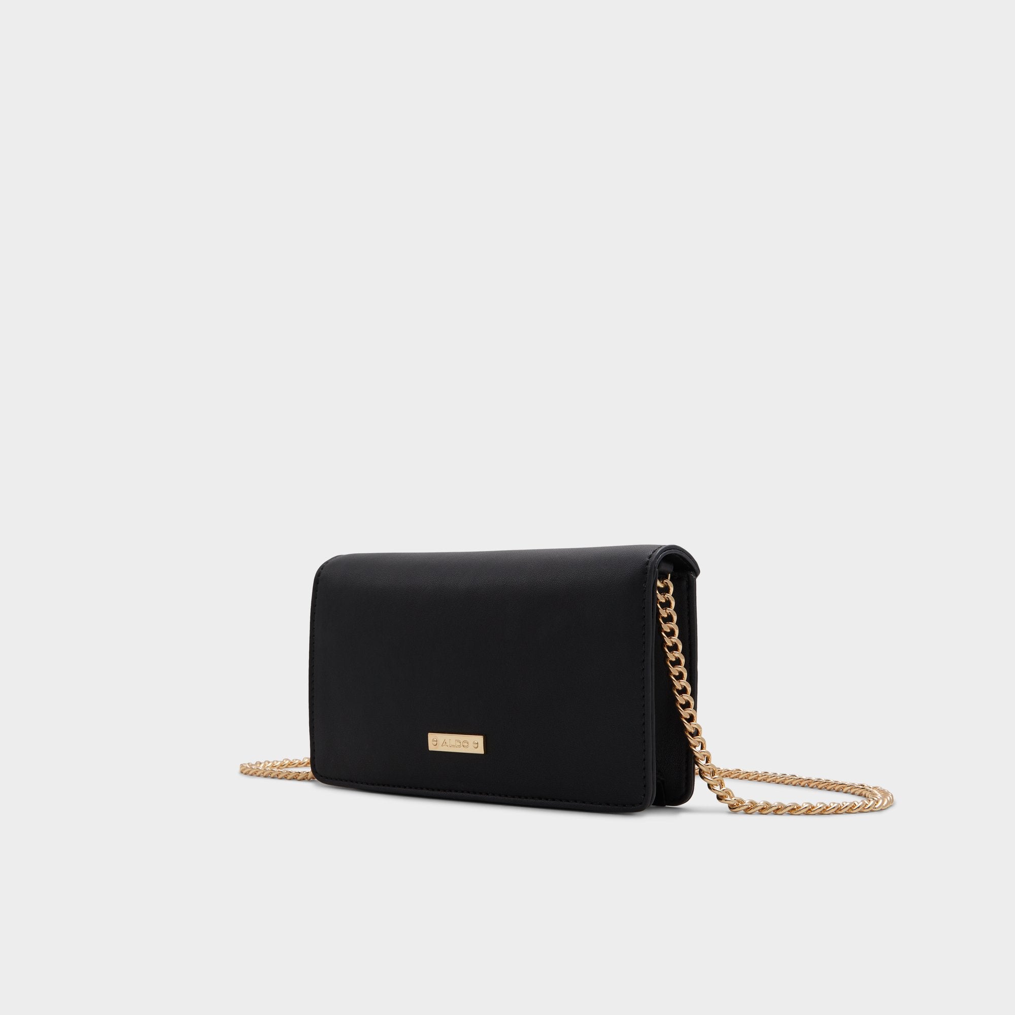 Black handbag with a gold chain on a light gray background