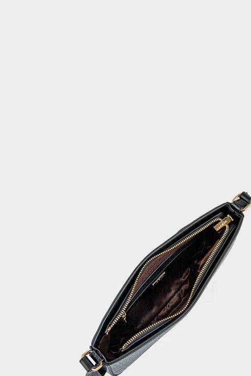 Black leather crossbody bag with gold zipper on a light gray background