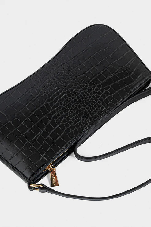 Black crocodile-patterned handbag on a light gray background