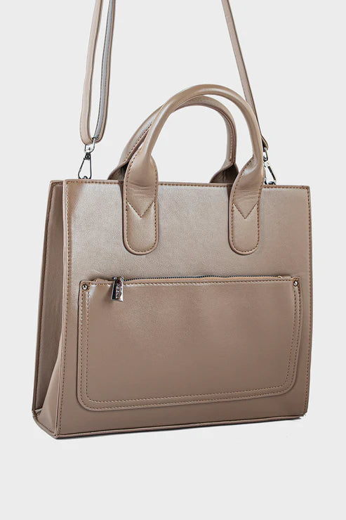 Beige handbag with a shoulder strap on a light gray background