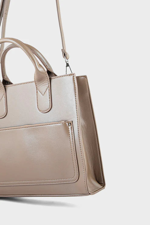 Beige handbag with a shoulder strap on a light gray background
