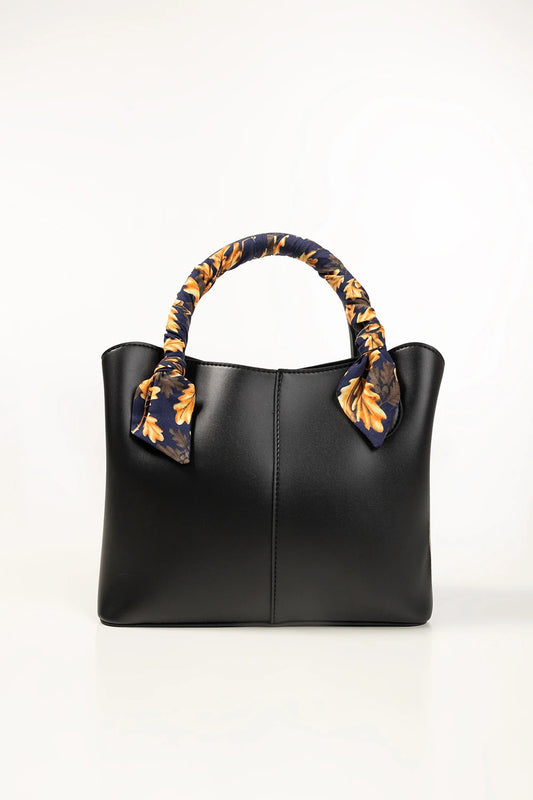 Black handbag with decorative floral handles on a white background