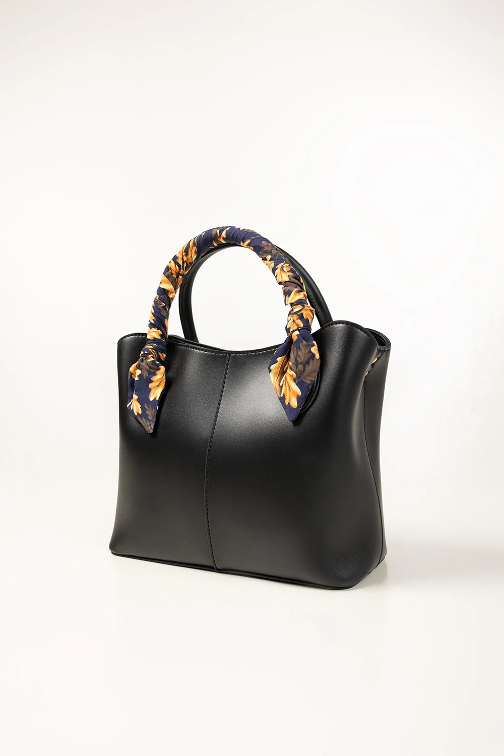Black handbag with floral-patterned handle on a white background