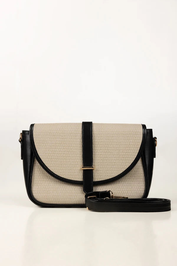 Beige and black handbag on a white background