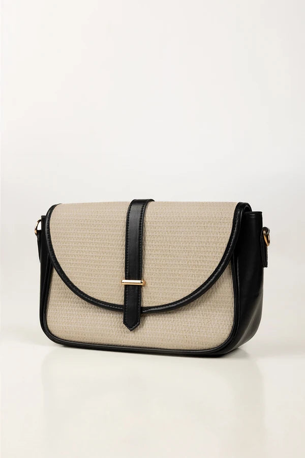 Beige and black handbag on a white background