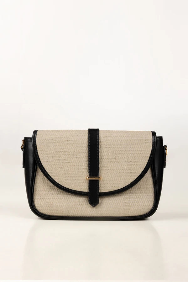 Beige and black handbag on a white background