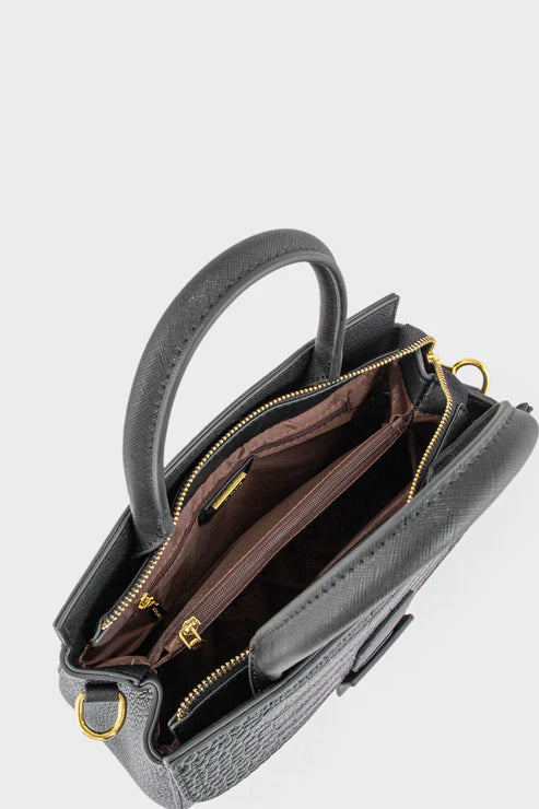 Gray handbag with gold zippers on a light gray background