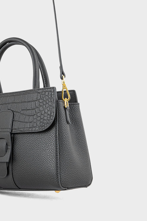 Gray handbag with a gold clasp on a light gray background