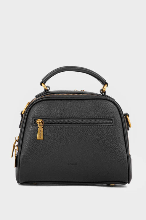 Black handbag with gold accents on a light gray background