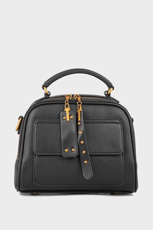 Black leather handbag with gold accents on a light gray background