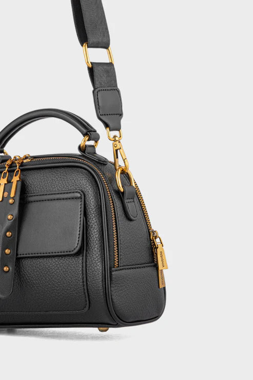 Black handbag with gold accents on a light gray background