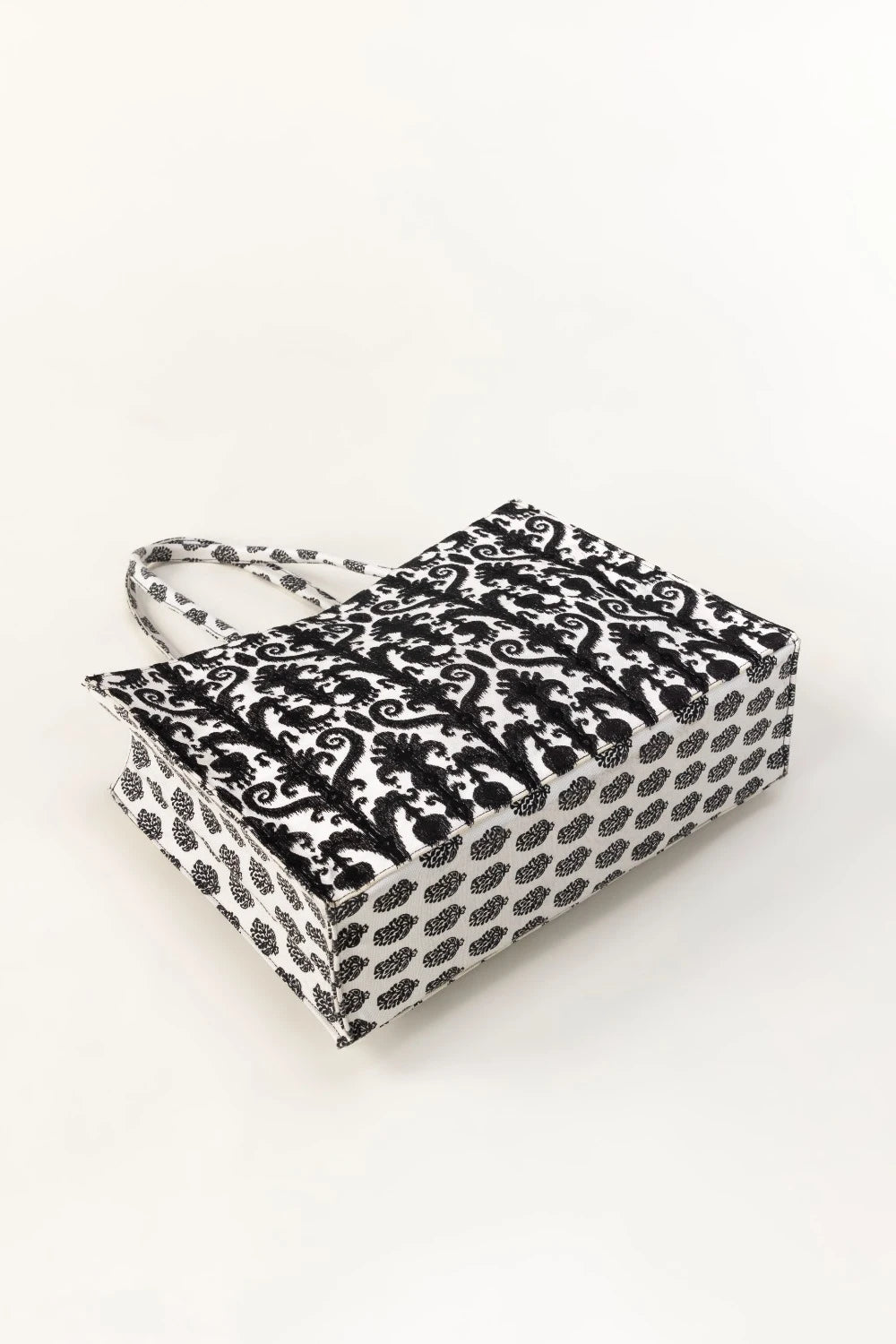 Black and white patterned box with handle on a white background