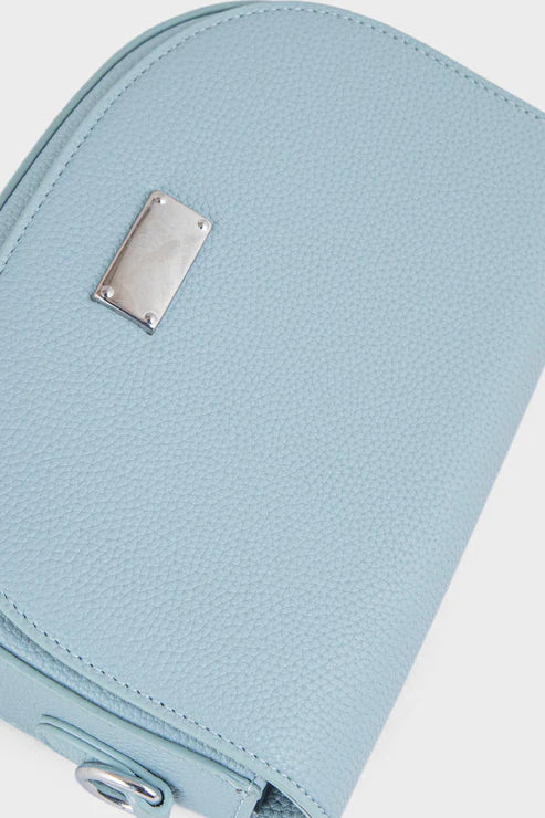 Light blue textured pouch with a metal tag on a white background