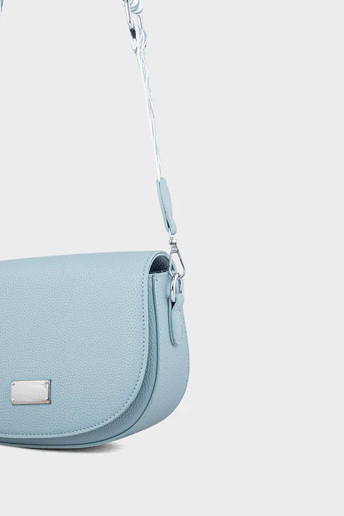 Light blue handbag with a strap on a white background