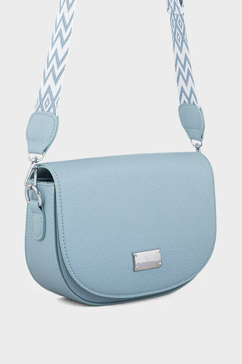 Light blue handbag with a patterned strap on a white background