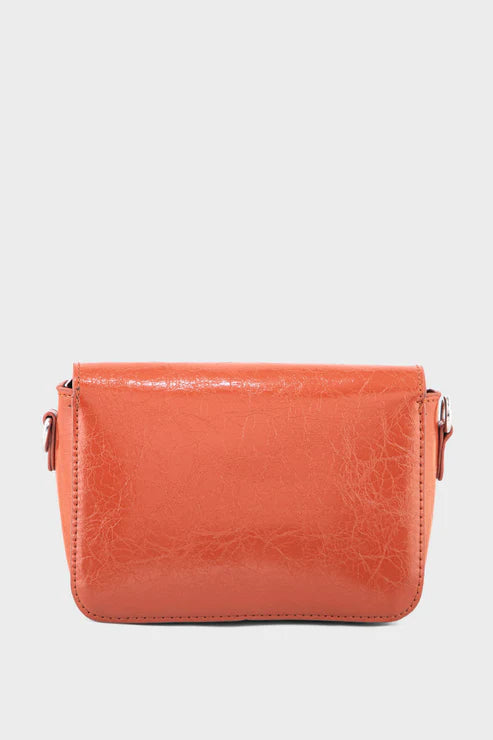 Orange leather crossbody bag on a light gray background