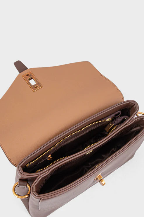 Brown handbag with gold accents on a light gray background