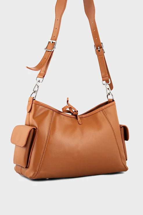 Brown leather handbag with a shoulder strap on a light gray background