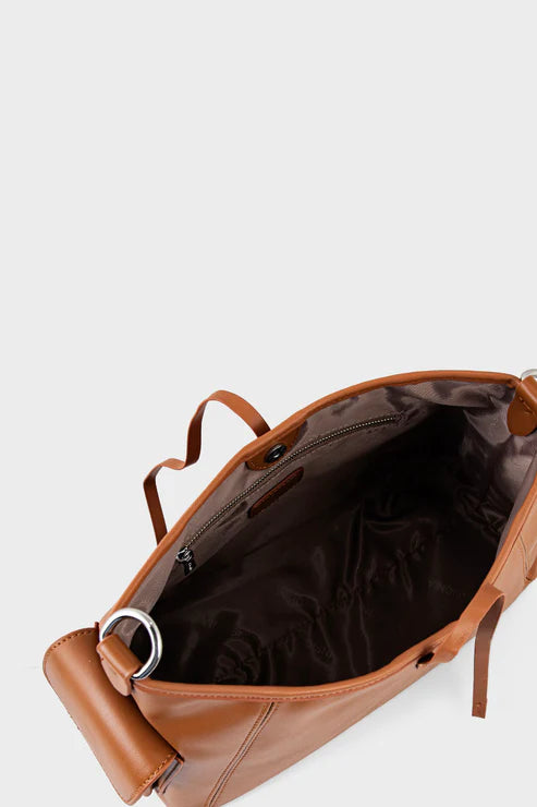 Brown leather bag with a silver buckle on a light gray background