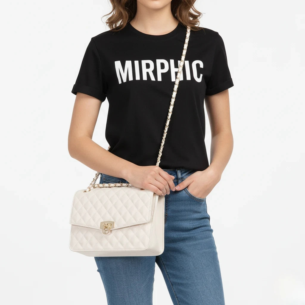Person wearing a black t-shirt with 'MIRPHIC' text, holding a white quilted handbag on a plain background