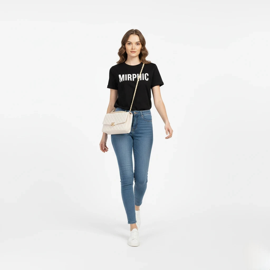 Woman wearing a black t-shirt with 'MIRPHIC' text, blue jeans, and white sneakers on a white background.