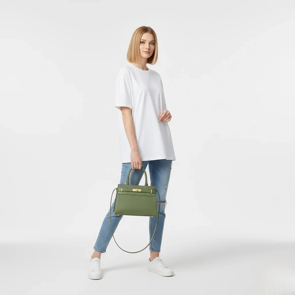 Woman holding a green handbag against a white background