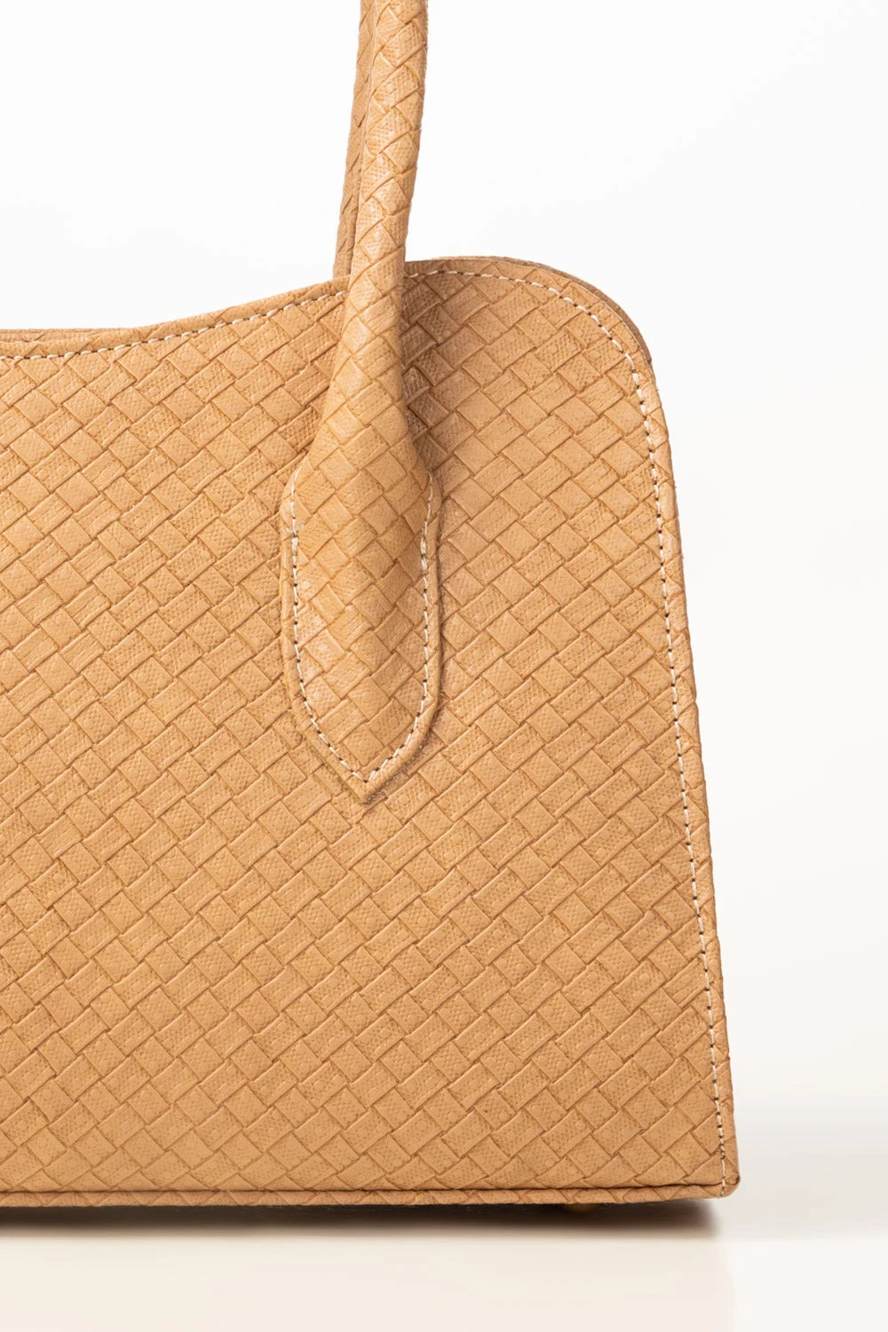 Close-up of a tan woven handbag on a white background