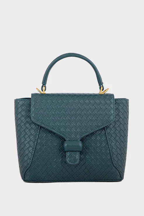Teal handbag with a textured pattern on a light gray background