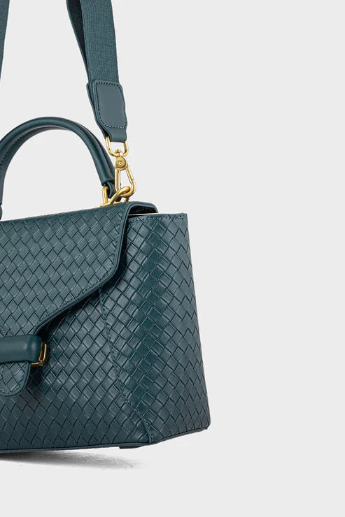Green woven handbag with a gold clasp on a light gray background