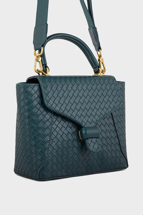 Green woven handbag with gold accents on a light gray background