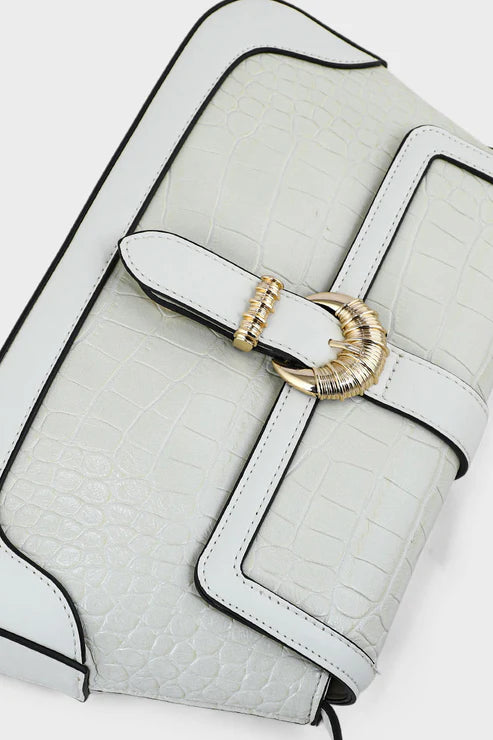 White handbag with a gold buckle on a light gray background