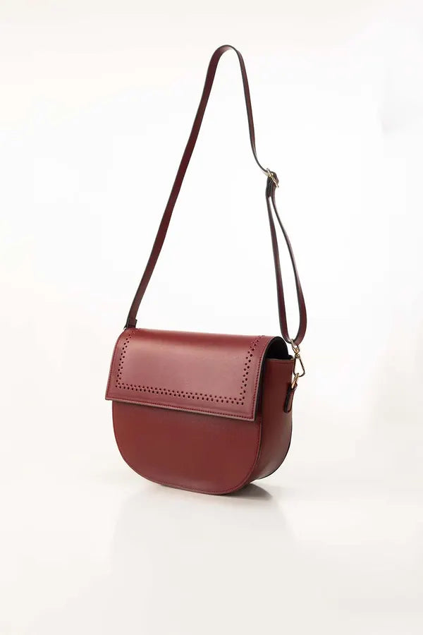 Red handbag with a strap on a white background