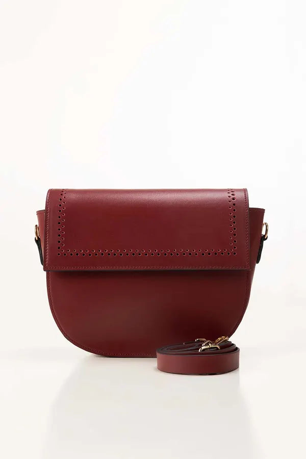 Red leather crossbody bag on a white background