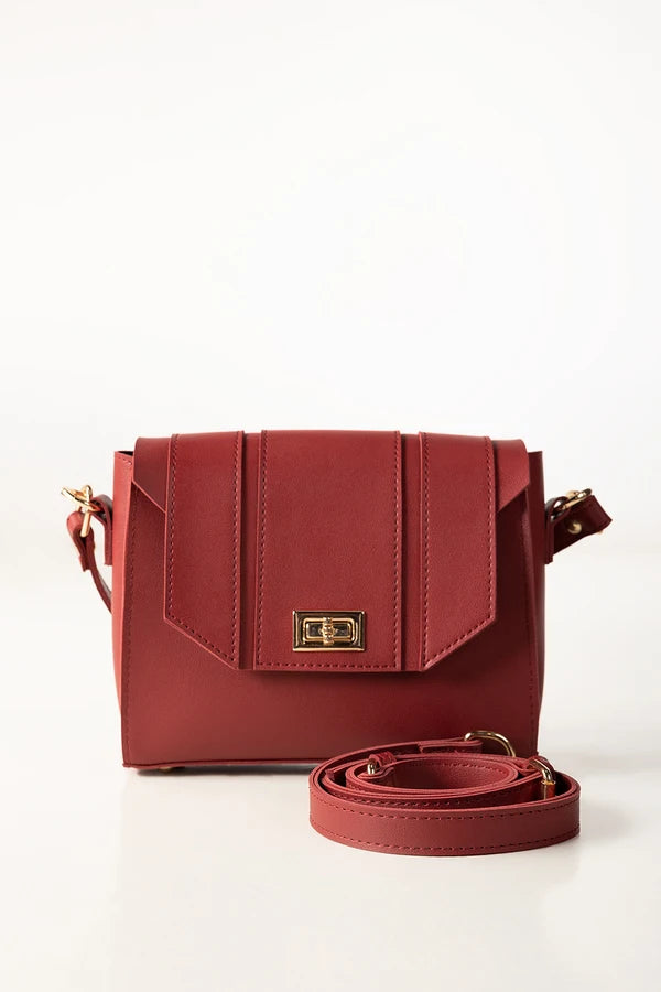 Red handbag with a gold clasp on a white background